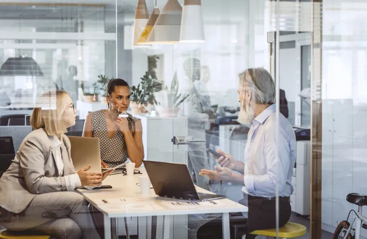 Accountant sitting with two business owners